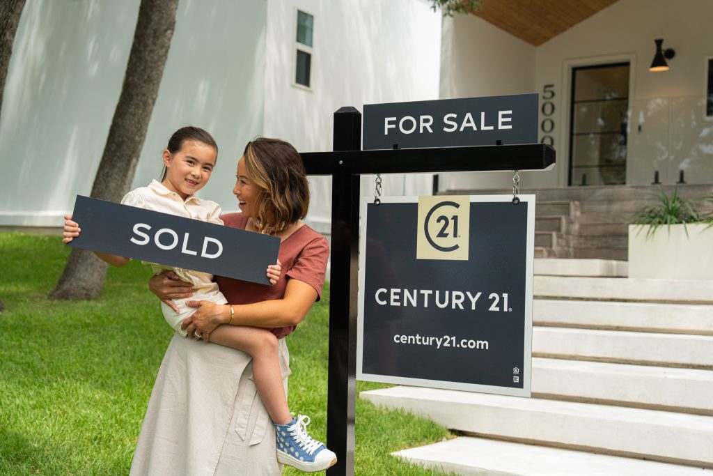 Mom and Daughter With Sold Sign